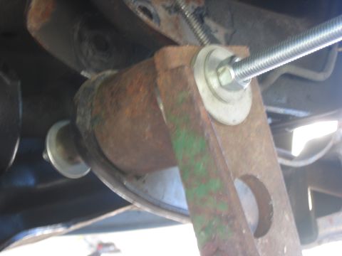 1996 Ford Bronco - Rusted metal bracket with a bolt and washers, likely part of a vehicle lift installation.