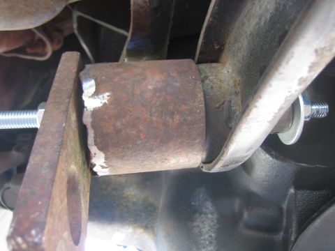 1996 Ford Bronco - Detail of a suspension component, likely during a lift installation, showing rust and a new bolt.