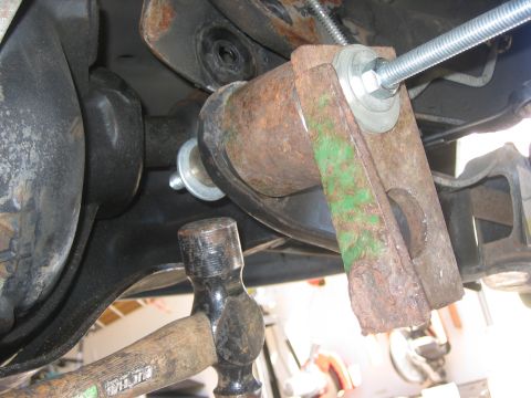 1996 Ford Bronco - Hammer and bolt used for suspension part installation.