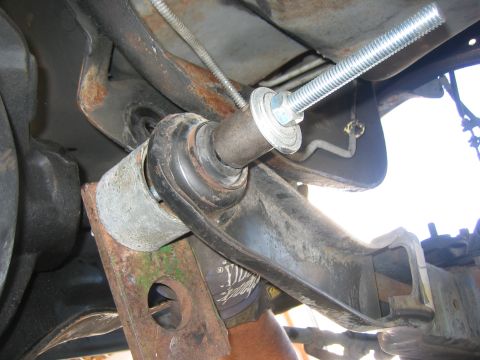 1996 Ford Bronco - Detail of a vehicle's suspension system, possibly during a lift installation or repair.