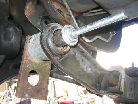 1996 Ford Bronco - A close-up view of a vehicle's suspension system, showing a modified component with a threaded rod.