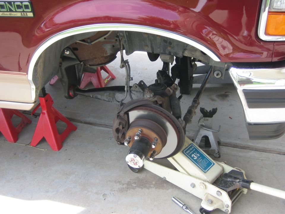 1996 Ford Bronco front suspension on jack stands with a floor jack