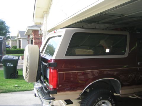 1996 Ford Bronco - Rear view of a 1996 Ford Bronco with a spare tire mounted on the tailgate.