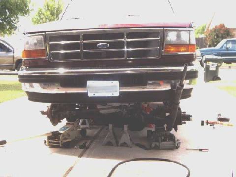 1996 Ford Bronco - Front end of a 1996 Ford Bronco raised on jack stands for maintenance or modification.