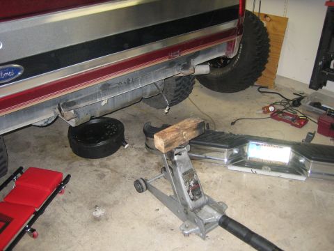 1996 Ford Bronco - Working on the rear bumper of a 1996 Ford Bronco, with an oil drain pan ready.