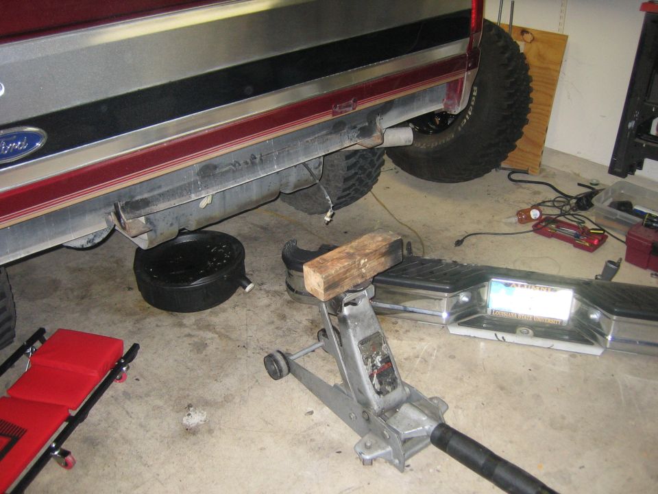 1996 Ford Bronco rear bumper removed, exhaust pipe visible, oil drain pan underneath