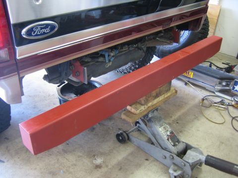 1996 Ford Bronco - Working on the rear bumper of a 1996 Ford Bronco, with a new steel bumper ready to be installed.