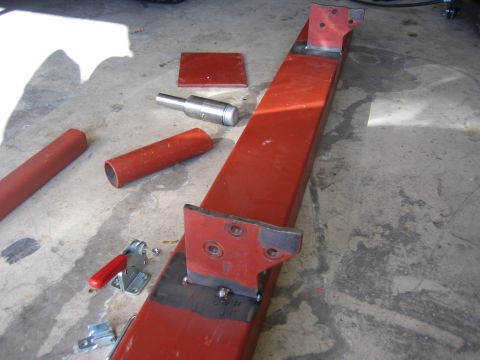 1996 Ford Bronco - Fabricated metal parts and tools are laid out on a concrete surface, suggesting a construction or repair project.