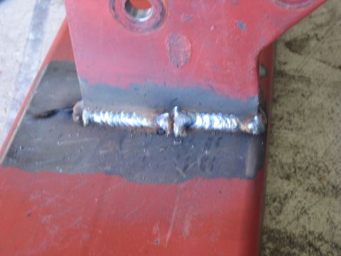 1996 Ford Bronco - Metal bracket with a welded seam, likely part of a larger assembly.