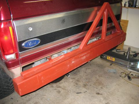1996 Ford Bronco - Custom tire carrier mounted on the rear bumper of a red Ford Bronco.