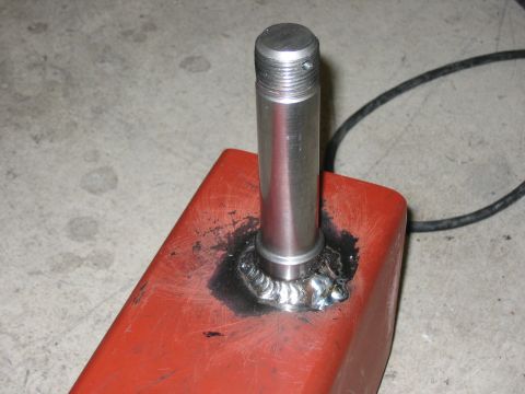 1996 Ford Bronco - A metal part, likely a component for a vehicle's rear bumper build, is shown after being welded.
