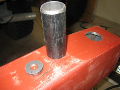 1996 Ford Bronco - Close-up of a metal pipe and washer on a red bracket, possibly for a vehicle part.