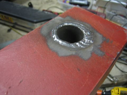 1996 Ford Bronco - A metal part shows a freshly welded circular opening.