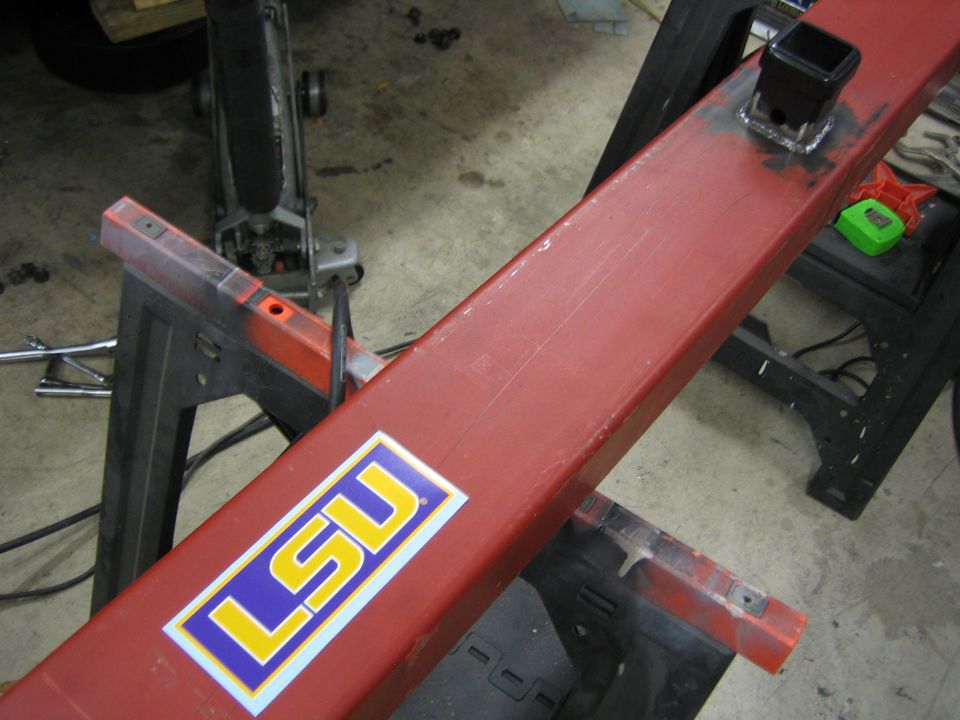 Red metal bar with LSU sticker and hitch receiver