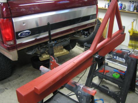 1996 Ford Bronco - A red aftermarket rear bumper assembly for a 1992 Ford Bronco is shown mounted on sawhorses.