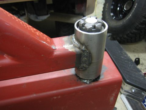 1996 Ford Bronco - Custom metal bracket assembly with a castle nut, likely for off-road vehicle modification.