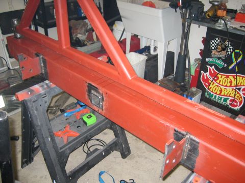 1996 Ford Bronco - A red metal bumper assembly is shown on sawhorses, with visible welding and a square cutout.