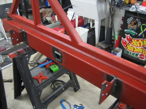 1996 Ford Bronco - Custom red metal bumper assembly, likely for an off-road vehicle, is shown on sawhorses in a workshop.
