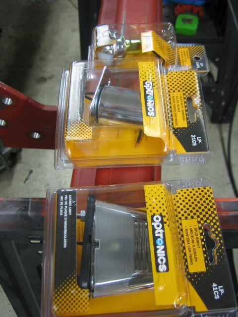 1996 Ford Bronco - Optronics license plate lights, one for stud mount and one for flush mount, are shown in their retail packaging.