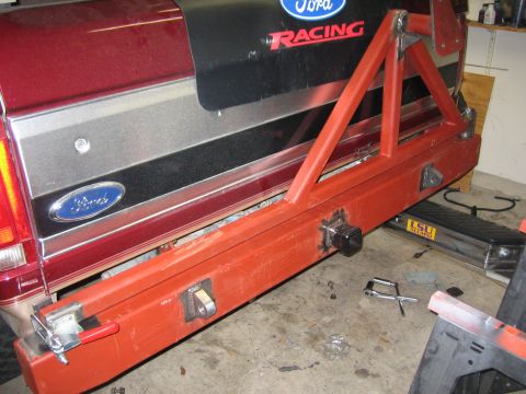 1996 Ford Bronco - A custom-built orange rear bumper and tire carrier is attached to a red Ford Bronco.