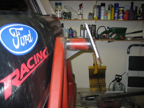 1996 Ford Bronco - Vehicle fender with Ford Racing sticker and attached red metal component.