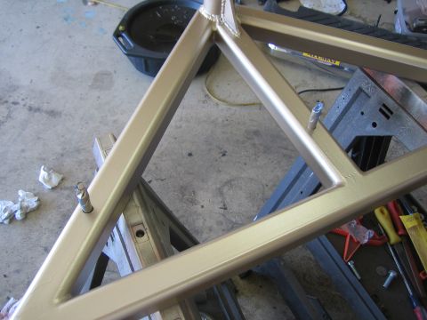 1996 Ford Bronco - A gold metal frame, possibly part of a bumper build, is shown on sawhorses with tools and an oil drain pan nearby.