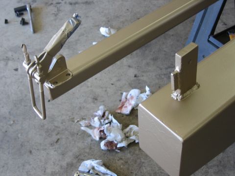 1996 Ford Bronco - Tan trailer hitch receiver and mounting bracket with used rags on a concrete floor.