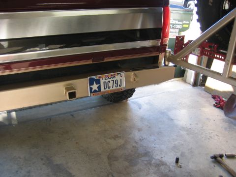 1996 Ford Bronco - The rear bumper of a vehicle is shown with a Texas license plate and metallic trim.