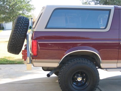 1996 Ford Bronco - Rear view of a 1996 Ford Bronco showing the quarter panel and external spare tire mount.