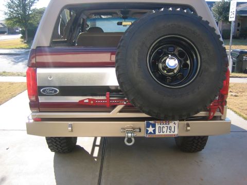 1996 Ford Bronco - Rear view of a 1996 Ford Bronco, a custom bumper, spare tire, and a Hi-Lift jack mounted on the tailgate.