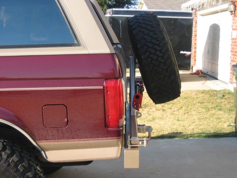 1996 Ford Bronco - Aftermarket spare tire carrier attached to the rear bumper of a vehicle.