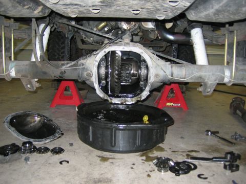 1996 Ford Bronco - Differential gears and tools are laid out around an open differential housing, suggesting a gear or locker installation.