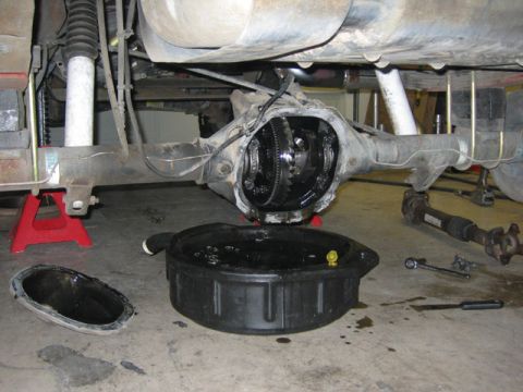 1996 Ford Bronco - Rear axle differential removed for service, showing gears and oil pan.