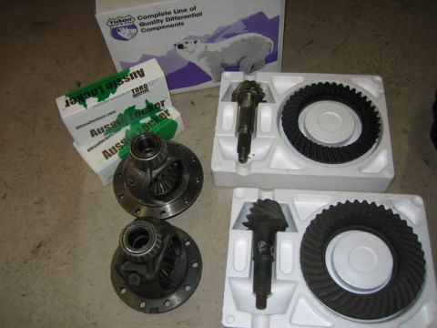 1996 Ford Bronco - Differential gears and lockers are laid out on the floor next to their packaging.