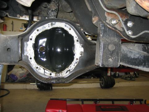 1996 Ford Bronco - Differential housing with gasket removed, revealing internal gears and oil residue.