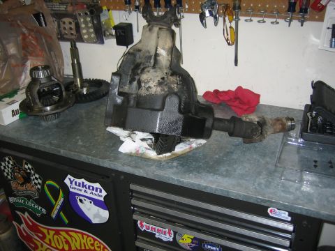 1996 Ford Bronco - Differential and driveshaft parts are laid out on a workbench, likely for installation or repair.