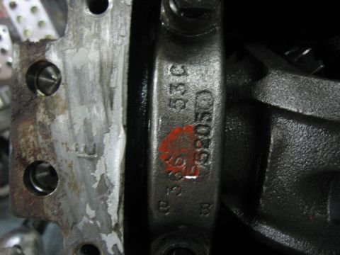 1996 Ford Bronco - Close-up of an engine component showing stamped identification numbers and a red mark.