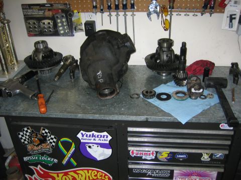 1996 Ford Bronco - Various differential components and tools are organized on a workbench, suggesting a gear or locker installation project.