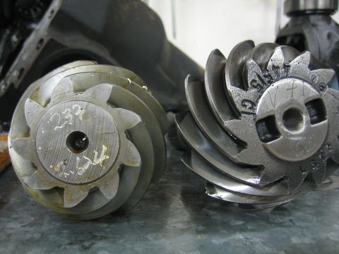 1996 Ford Bronco - Close-up of two differential gears, one with handwritten markings and the other with stamped identification.