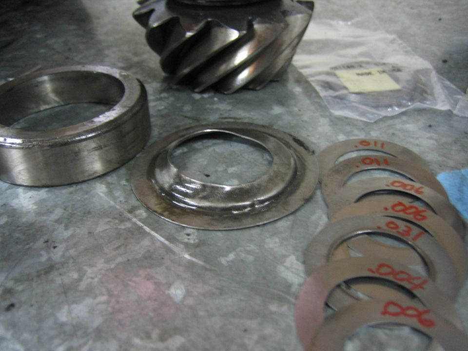 Differential ring gear, pinion gear, bearing, and stack of shims with thickness markings
