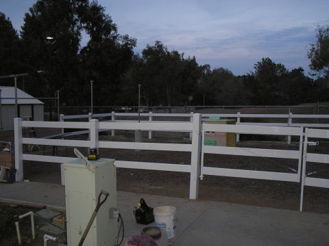 1990 Ford Bronco - Outdoor scene with a white fence and construction equipment in the foreground.