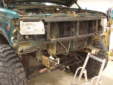 1996 Ford Bronco - Front view of a 1996 Ford Bronco undergoing repairs, with the grille and radiator visible.