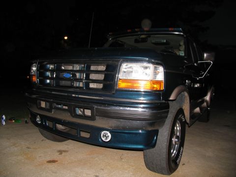 1995 Ford C-350 (Centurion Conversions) - Front view of a dark teal Ford truck with a chrome grille and amber turn signals.