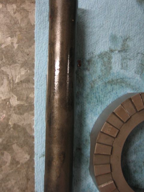 1996 Ford Bronco - Close-up of a metal shaft and a gear part, likely related to a vehicle's drivetrain or locker installation.