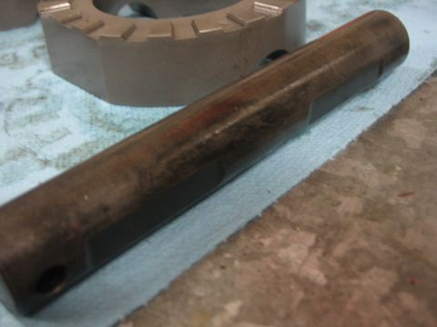 1996 Ford Bronco - Close-up of a metal shaft and a gear, likely automotive parts.