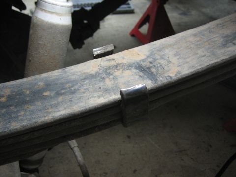 1996 Ford Bronco - Close-up of a vehicle's rear suspension components, including a leaf spring and shock absorber.