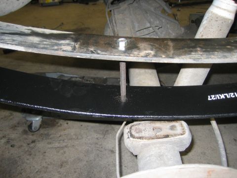 1996 Ford Bronco - New leaf spring installed on vehicle suspension system, showing part number 12/LK127.