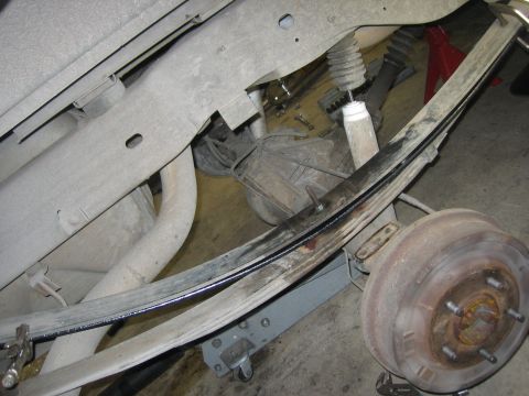 1996 Ford Bronco - Close-up view of the rear suspension system, focusing on the leaf spring and associated components.