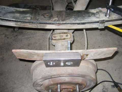 1996 Ford Bronco - Rear axle and leaf spring assembly with a custom metal bracket installed.