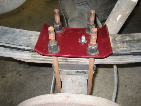 1996 Ford Bronco - Close-up of a vehicle's rear suspension components, including leaf springs and U-bolts.